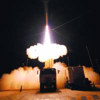 On guard: The land-based missile defense system heading for the Pacific island of Guam includes a truck-mounted launcher, tracking radar and interceptor missiles. North Korea shifts missile to coast; U.S. deploys defenses