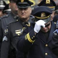 One of their own: Police enter a memorial service for slain Massachusetts Institute of Technology police officer Sean Collier in Cambridge on Wednesday. Collier was fatally shot on the MIT campus April 18. CIA asked that bomber be put on terror watch list