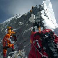 The only way is up: Alpinists climb past Hillary Step as they head for the summit of Mount Everest. It will be 60 years ago Wednesday that New Zealander Edmund Hillary and Tenzing Norgay of Nepal conquered the 8,848-meter-high mountain. Everest tamed six decades ago