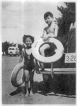 Life's a beach: Norio Minorikawa, as the star was born, pictured on holiday, aged 9, with his sister. Japan's 'Mr. Television'