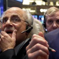 Second thoughts: Trader Peter Tuchman works the floor of the New York Stock Exchange on Thursday. On Wall Street, traders are worried about how committed the Federal Reserve is to maintaining its unorthodox bond-buying program. Goldman's buybacks hit highest of year amid slide