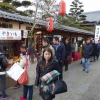 Beckoning: Travel agency officials and others from Shanghai stroll past shops and restaurants at the entrance to Ise Jingu Shrine in Ise, Mie Prefecture, in late February. Chubu's 'Dragon Route' resumes bid to lure tourists