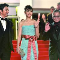 CANNES DO ATTITUDE: Actors Takao Osawa (left) and Nanako Matsushita, and director Takashi Miike, arrive Monday for the screening of the film “Shield of Straw” (“Wara no Tate”) at the 66th edition of the Cannes Film Festival in France. Miike’s gore-filled flick panned at Cannes