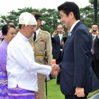 Hand in hand: Myanmar President Thein Sein greets Prime Minister Shinzo Abe at the Presidential Palace in Naypyitaw on Sunday. Abe's Myanmar visit may help Japan parry China's influence