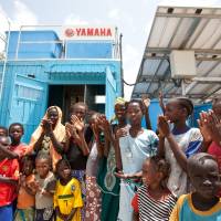 Turning on the tap: Senegalese villagers gather around a water treatment plant in Ndiawdoune Nar last August. From base of social pyramid, only way is up