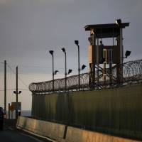 Blot on the copybook: U.S. personnel guard the detention facility at the naval base in Guantanamo Bay, Cuba. Obama's Gitmo plan still faces huge hurdles