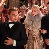 Great party: Leonardo DiCaprio (left) speaks with co-stars Carey Mulligan (center) and Joel Edgerton in a scene from director Baz Luhrmann’s “The Great Gatsby.” DiCaprio says he doesn’t share too much in common with his character, Jay Gatsby, who is presented as an extremely flashy type. 'Great Gatsby' reunites Luhrmann, DiCaprio