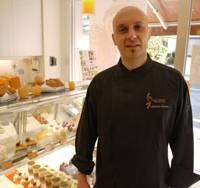 Epicurean delights: Antoine Santos stands beside a display case filled with desserts at his pastry shop and school Ecole Criollo in Toshima Ward, Tokyo. French patissier's dream becomes reality in Japan