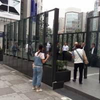 Lighting up a storm: The new smoking area in front of the East Exit of Ikebukuro Station in Tokyo's Toshima Ward is now open for business. Mr. Mayor, tear down this smoking area and make Toshima a true 'safe community'