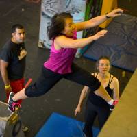 Leaps and bounds: Instructor Salil Maniktahla, left, observes a participant jump to a wall as part of a parkour class at Urban Evolutions in Alexandria, Virginia. Flying through an urban obstacle course like 007