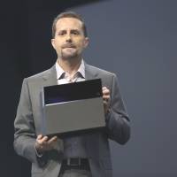 Game on: Andrew House, president and chief executive officer of Sony Computer Entertainment Inc., is seen with the PlayStation 4 console on Monday. CEO: PS4 to tap new revenue streams