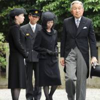 A family affair: Emperor Akihito visits the grave of Prince Tomohito of Mikasa in Tokyo’s Bunkyo Ward Monday, followed by the late prince’s daughters, Princesses Akiko (center) and Yoko. Empress Michiko did not accompany the Emperor, having suspended her official duties for the beginning of the week to recover from fatigue. Prince's 2012 passing reduces Imperial household families by one