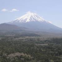 Climb at your expense: Yamanashi and Shizuoka prefectures will starting on a trial basis charging a fee this summer to climb Mount Fuji, as seen in April from the Yamanashi town of Fujikawaguchiko. Fuji-bound hikers face summer fees