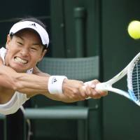 Inspiration for all ages: Kimiko Date-Krumm plays a shot during her Wimbledon singles match against Romania’s Alexandra Cadantu on Thursday. The 42-year-old Date-Krumm won 6-4, 7-5, becoming the oldest woman to advance to the Grand Slam tournament’s third round since the Open era began in 1968. Date-Krumm sets Wimbledon age record at 42