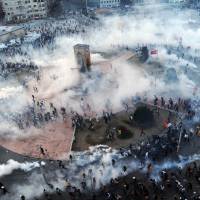 2020 Olympic bid in question: Protesters flee as Turkish riot police fire tear gas in Taksim Square on Wednesday. Istanbul riots raise questions over city's Olympic bid