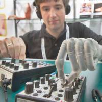 Bionic man: Born without a left hand, Bertolt Meyer received a bionic hand developed by Scottish company Touch Bionics at the age of 19. Here he operates a music console in 2010 at the Orthopedic and Rehabilitation Technology fair in Germany. Robotics about to transform our notion of what is 'human'