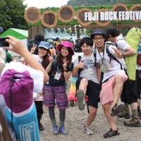 Visitors to this year’s Fuji Rock Festival, which kicks off today and runs till July 28, pose for commemorative photos at the fest entranceway, which covers much of the Naeba ski resort. Storify: Fuji Rock Festival 2013