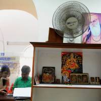 End of an era: Customers wait at the counter at the Central Telegraph Office in New Delhi on Wednesday. After 162 years of helping people stay in contact, India will close the world's last major telegram service next Monday. India to close telegraph system after 162 years