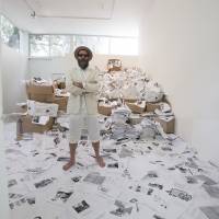 Internet printed: U.S. poet Kenneth Goldsmith stands with 10 tons of printed Web pages from the “Printing Out the Internet” exhibit he’s coordinating at the Labor art gallery in Mexico City. Crowdsourced art project to printout the Web honors free-information activist