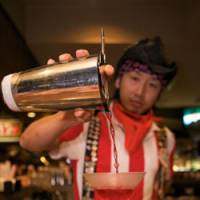 Salut!: Keisuke Goto rounds off a show at TGI Friday's. Japan's cocktail king leaves the world reeling from his alco-antics