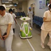 Future shock: Staff, including a receptionist robot, work at a hospital in Aizu Wakamatsu, Fukushima Prefecture. Brace for a possible spring shock