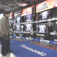 Spoiled for choice: A customer looks at Panasonic Corp. Viera televisions displayed at an electronics store in Tokyo in February. Panasonic 'smart' TV ad nixed by broadcasters