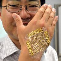 Skintight: University of Tokyo professor Takao Someya displays the world’s lightest and thinnest flexible integrated circuits and touch sensor system for stress-free wearable health care sensors Wednesday in Tokyo. Japan team develops microthin electric circuit