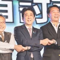 Big divided family: Prime Minister Shinzo Abe is flanked by Democratic Party of Japan President Banri Kaieda (right) and Your Party leader Yoshimi Watanabe after their June 28 Tokyo “debate.” LDP spin team hammers voters with 'Abenomics' mantra