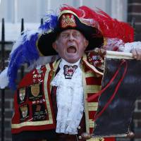 Hear ye, hear ye: Tony Appleton, a town crier, announces the birth of the royal baby Monday, outside St. Mary's Hospital exclusive Lindo Wing in London. U.K. royal birth sparks international frenzy