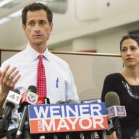 Major boner: New York mayoral candidate Anthony Weiner holds a news conference with his wife, Huma Abedin, in the Big Apple on Tuesday after a website revealed another batch of explicit communications between the Democrat and a young woman. Weiner admits to more lewd photos