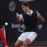 Pushed hard: Roger Federer plays a shot from Germany's Florian Mayer in their quarterfinal match at the German Tennis Championships on Friday. Federer won 7-6 (7-4), 3-6, 7-5. Federer battles way into Hamburg semis
