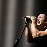 Trent Reznor’s Nine Inch Nails headlines the Green Stage during a sudden thunderstorm on Friday. A year of tough choices at Fuji