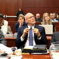 Self defense: George Zimmerman (right) with his attorneys, Mark O’Mara (left) and Don West, watch as an evidence video is projected on a screen during the 16th day of his trial in Seminole circuit court, in Sanford, Florida, on July 1. Race takes backseat at Zimmerman trial