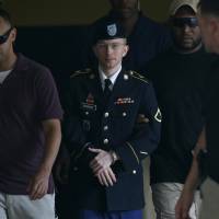 Over for another day: Army Pfc. Bradley Manning (center) is escorted to a security vehicle outside a courthouse in Fort Meade, Maryland, on Thursday, following another hearing. The military judge overseeing his trial refused a defense request to dismiss a charge that Manning aided the enemy. Manning trial judge declines to dismiss key charge he 'aided the enemy'