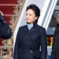 All business: Peng Liyuan is seen at an airport outside Moscow in March. Peng Liyuan, Chinese leader Xi's wife, callled best-dressed first lady