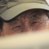 Fingers crossed: Hyun Chun-koom, 80, looks at a computer monitor at the headquarters of the Korean Red Cross in Seoul on Saturday. Hyun was among hundreds of candidates vying for slots to meet with their long-separated North Korean relatives during family reunions planned for late September. Koreas agree to let families reunite in North