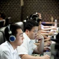 Big hack attack: Customers use computers at an Internet cafe in Beijing. A government-linked agency has claimed that a sustained cyberattack over the weekend was the “largest ever” on the nation’s Internet infrastructure. Chinese Internet struck by 'largest cyberattack' ever