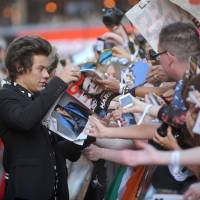 Red carpet excitement: One Direction’s Harry Styles signs autographs for fans at the premiere of his band’s documentary film in London on Tuesday. One Direction film premiere hits London