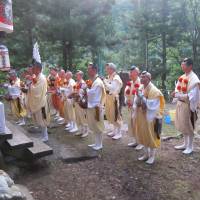 High life: Lay yamabushi (mountain mystics) from Shimizu pray at a shrine prior to their annual fire-walking ritual. Eco-awareness to the rescue
