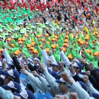 Making a statement: Farmers raise their fists at a rally against Japan’s participation in the negotiations for the U.S.-led Trans-Pacific Partnership agreement Tokyo in October 2011. Japan increases TPP possibilities but not its own competitiveness