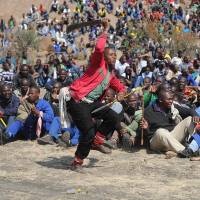 Platinum class: Miners demonstrate at a mountain close to the facility near Rustenburg to demand that their wages be more than tripled. A South African union said a local leader was shot dead at Lonmin’s Marikana mine Monday, almost a year after police shot to death 34 strikers in the restive platinum belt. Bloodbath still haunts South Africa's platinum belt