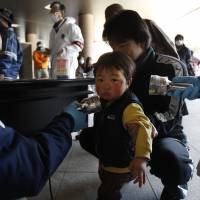 Fears for the future: A child is screened for radiation shortly after the accident at Fukushima No.1 nuclear power plant in 2011. Fukushima Medical School continues to monitor some 360,000 under-18s for signs of cancer. Fukushima: health disaster or PR fail?