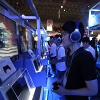 Game on: People try out Sony’s PlayStation4 video game consoles at the Tokyo Game Show on Thursday at Makuhari Messe convention hall in Chiba Prefecture. Sony expects sales of the new PS4 to reach 5 million units this fiscal year. Sony expects price, content to up PS4 sales
