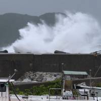 Making waves: High waves crash into a breakwater in Kumano, Mie Prefecture, Sunday afternoon as Typhoon Man-yi made its way toward Honshu. Typhoon Man-yi heads for Chubu