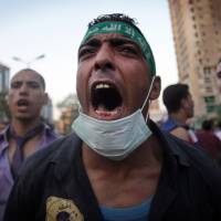 Rebel yell: Supporters of Egypt’s ousted president, Mohammed Morsi, chant slogans during a protest in Cairo on Friday. Egypt court jails 52 Muslim Brotherhood members