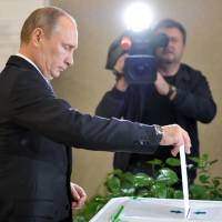 One president, one vote: Russian President Vladimir Putin casts his ballot at a polling station in Moscow on Sunday. Moscow mayor election could shift political landscape