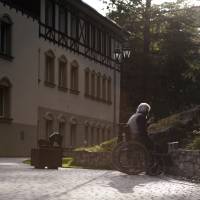 Finding another way: A resident sits in a wheelchair and smokes a cigarette on the grounds of the care home where he lives in Szklarska Poreba, Poland, on Aug. 24. Polish nursing homes have seen a rise in Germans seeking affordable elderly care, while one German newspaper denounced it as gerontologic colonialism. 'Grandma export' exposes Germany's struggle with care