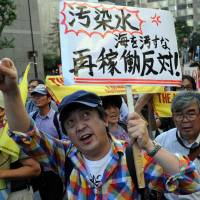 Resistance: Protestors raise signs and shout during an antinuclear demonstration in Tokyo on Sunday. Thousands mass for antinuclear rally in Tokyo