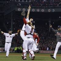Boston Strong: Koji Uehara (left) jumps into the arms of catcher David Ross as the Red Sox celebrate after winning the 2013 World Series on Wednesday at Fenway Park. Uehara fans final batter as Red Sox win World Series