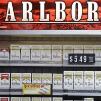 Smoked out: Marlboro cigarette packs are displayed in a Little Rock, Arkansas, on Wednesday. Marlboro's red-and-white box and distinct typeface created one of the world's most powerful brands, but in Australia, the red chevron is now taboo Australia's 'plain packaging' stubs out cigarette branding, prompts backlash